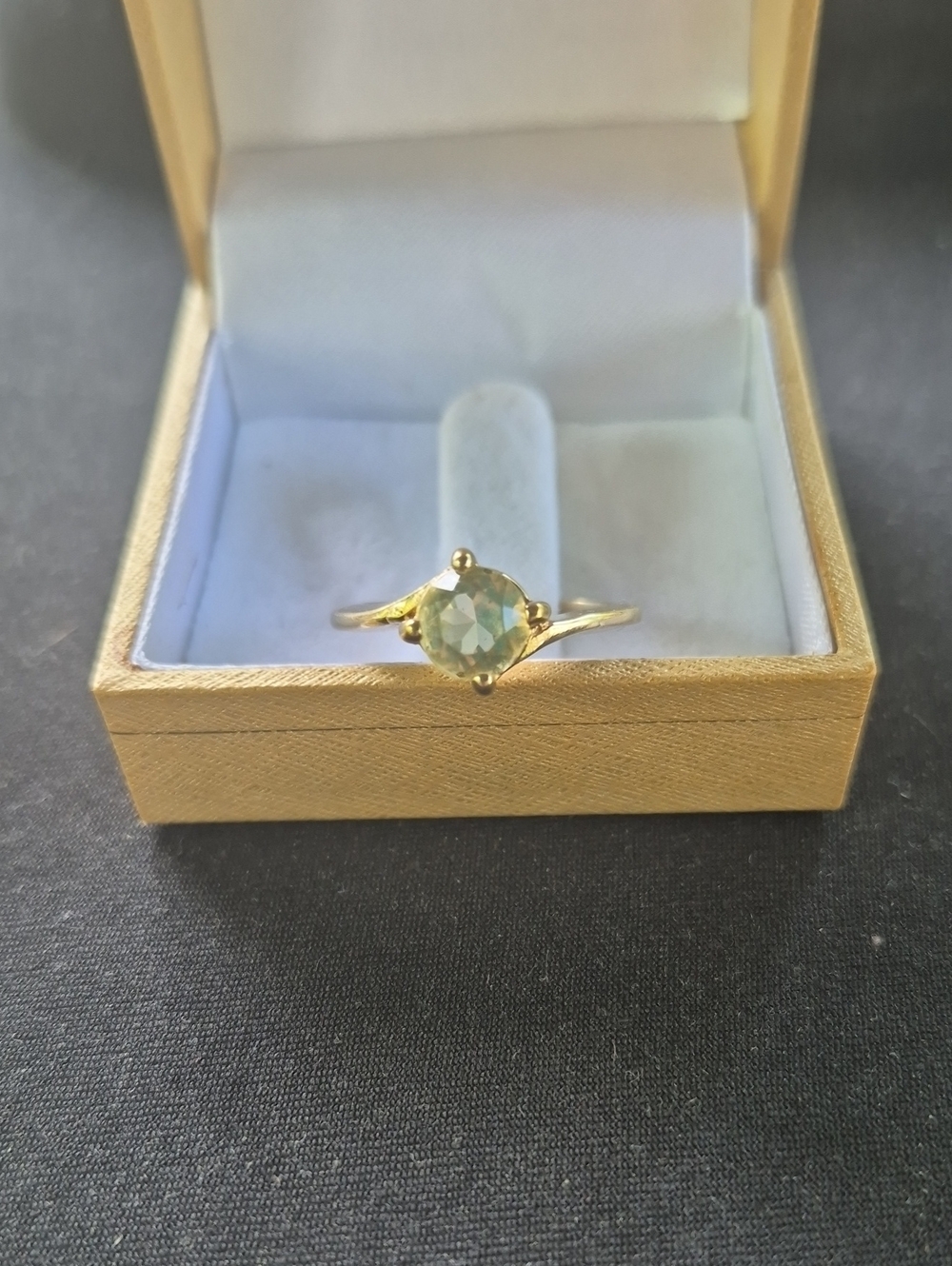 Vintage Avon gold plated with light green stone.